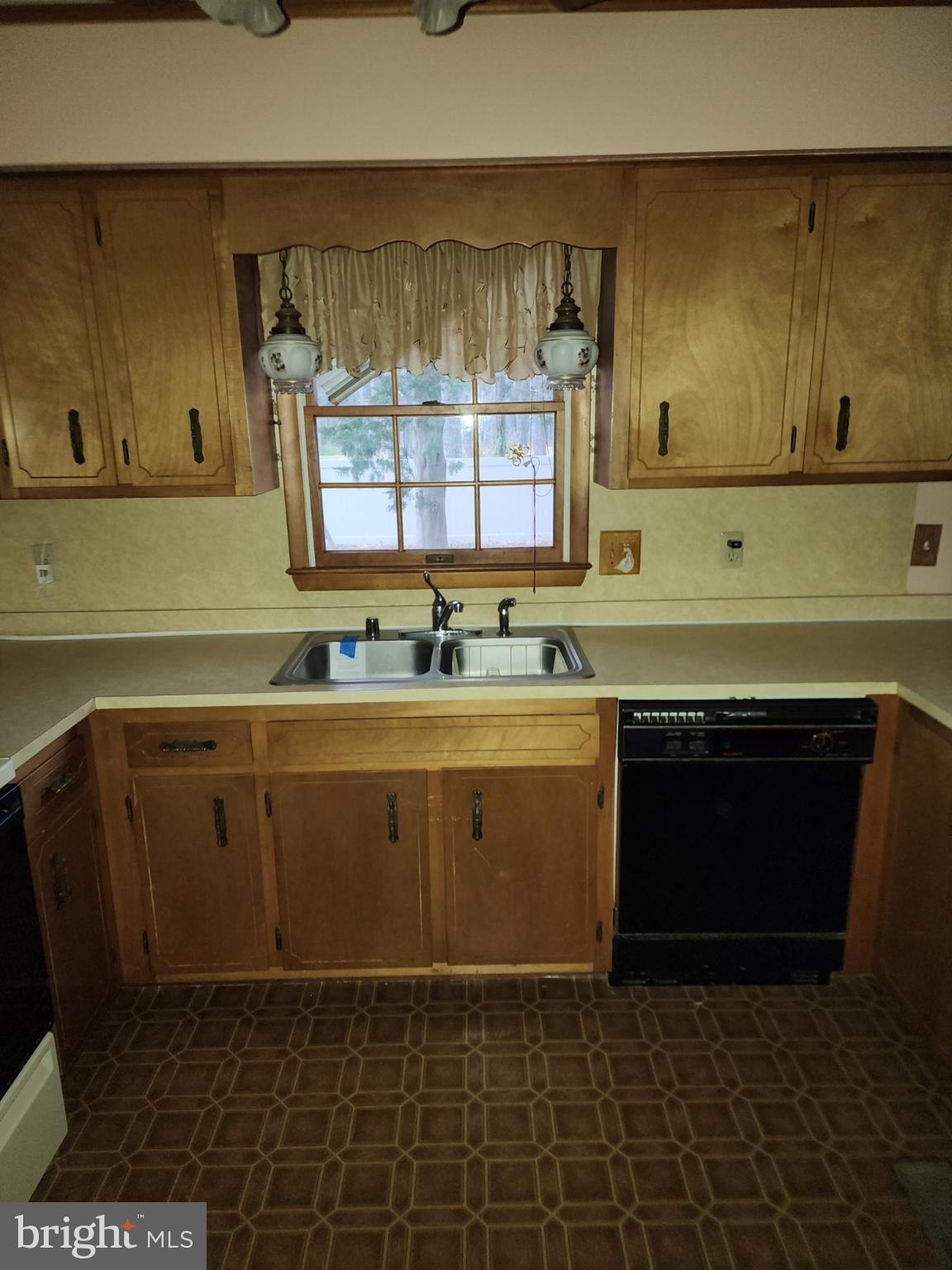 9310 Romancoke Road Stevensville, MD 21666 - Photo 31 of 35 a kitchen with a sink stove and cabinets