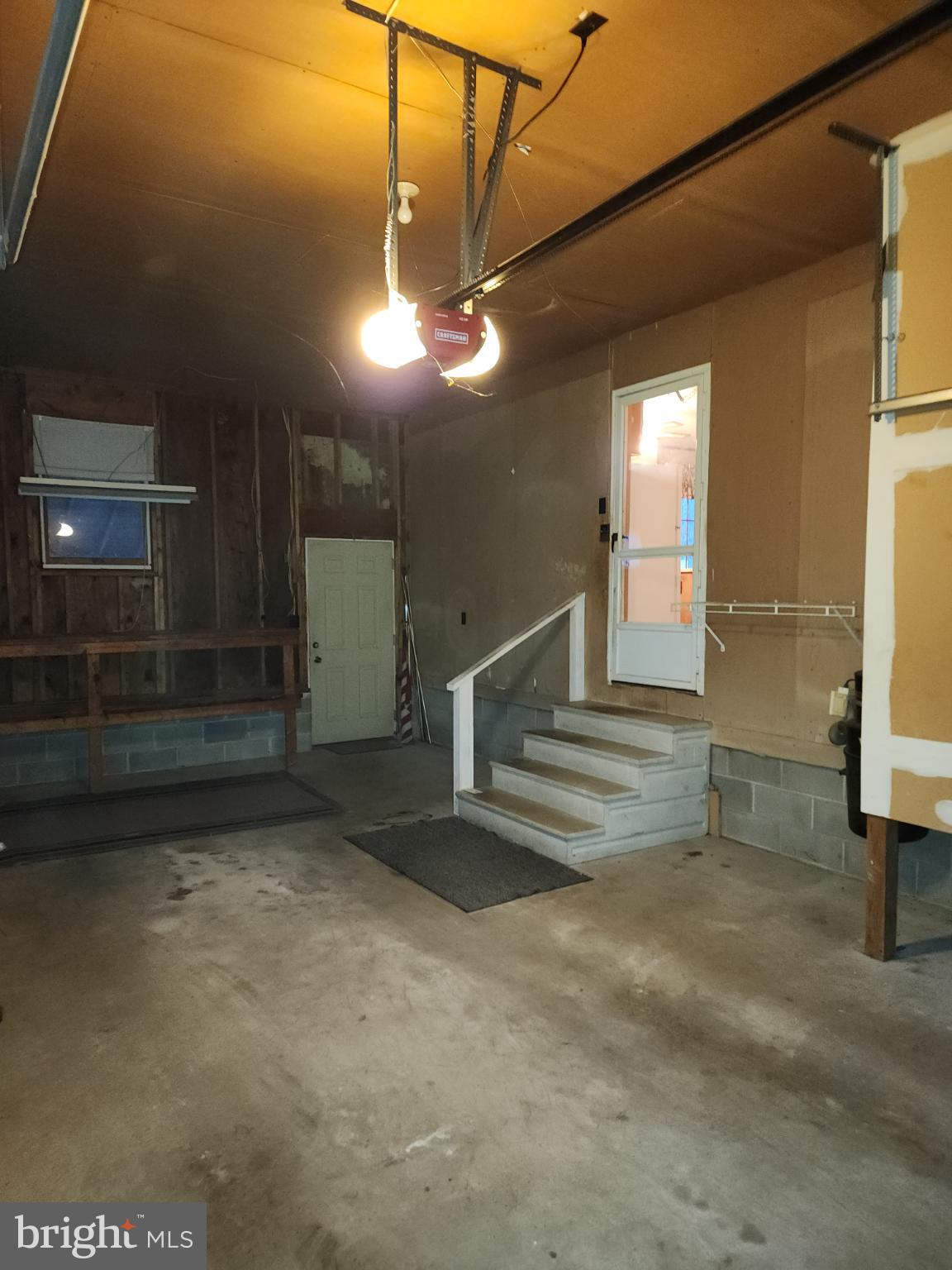 9310 Romancoke Road Stevensville, MD 21666 - Photo 35 of 35 a view of a room with stairs and a chandelier fan