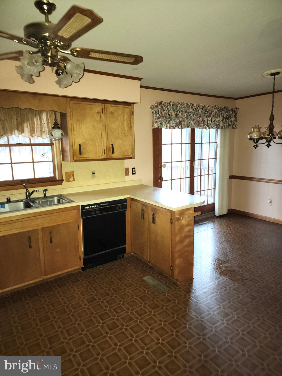 9310 Romancoke Road Stevensville, MD 21666 - Photo 8 of 35 a large kitchen with stainless steel appliances a stove a sink a window and a counter space