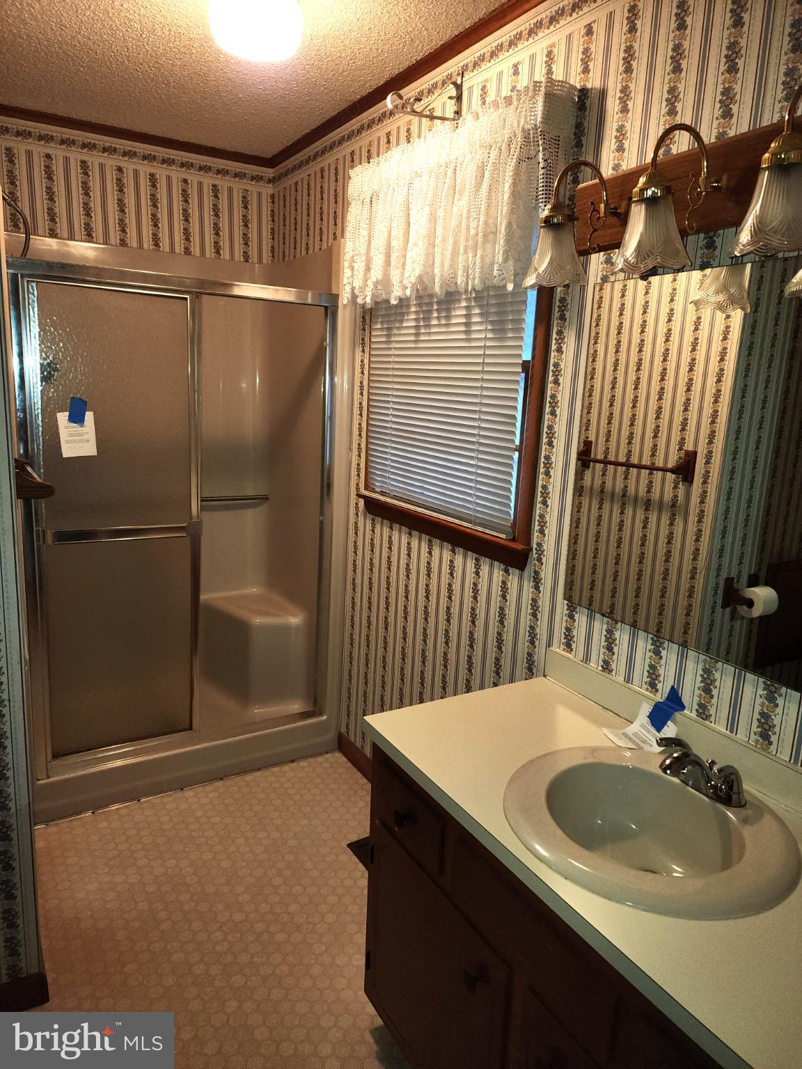 9310 Romancoke Road Stevensville, MD 21666 - Photo 10 of 35 a bathroom with a sink and mirror