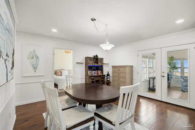 a dining room with furniture and wooden floor