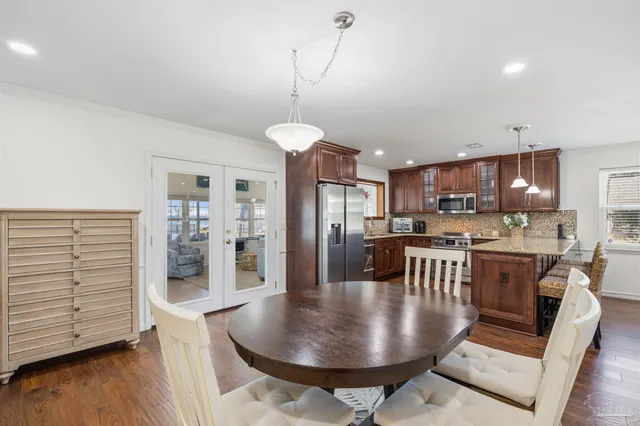 a view of a dining room with furniture and wooden floor