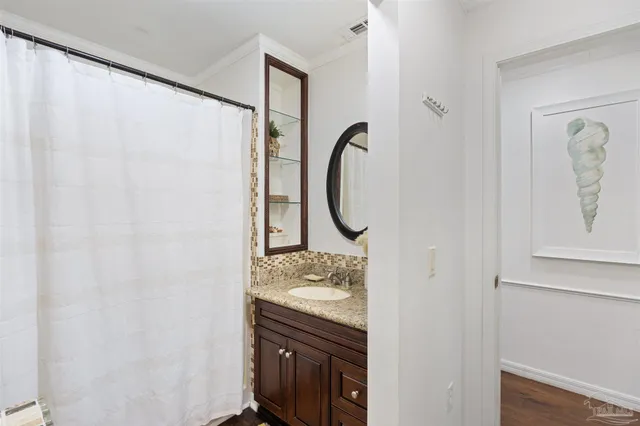 a bathroom with a granite countertop toilet sink and mirror