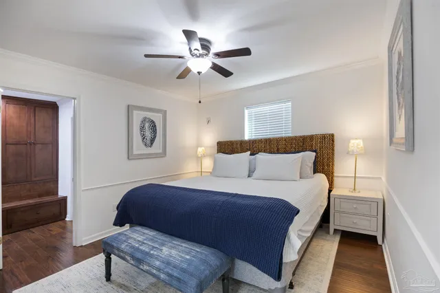a bedroom with bed and wooden floor