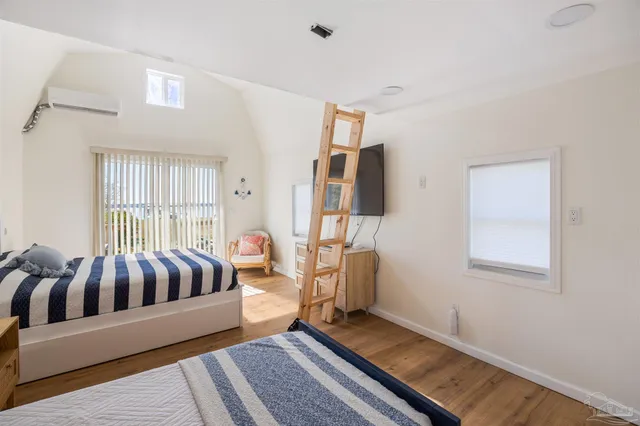 a living room with furniture kitchen view and a large window