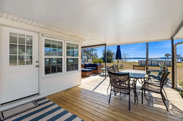 a view of a house with a wooden fence and a floor to ceiling window