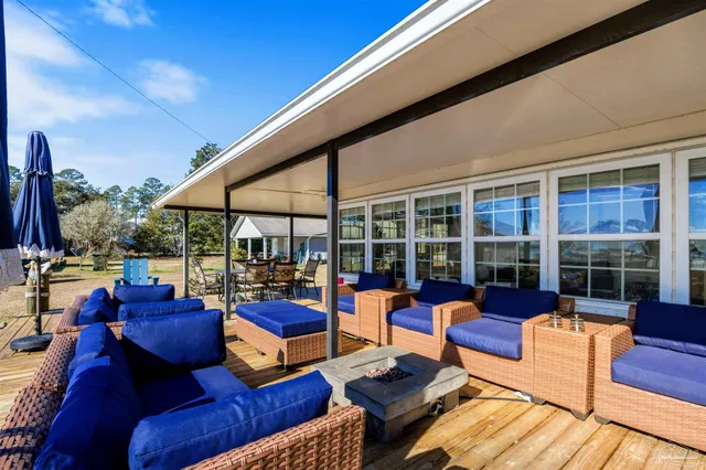 a view of a chairs and tables in the patio of a house