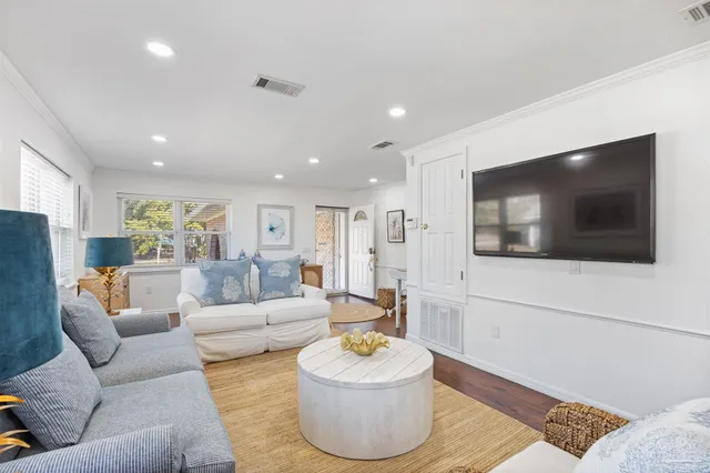 a living room with fireplace furniture and a wooden floor