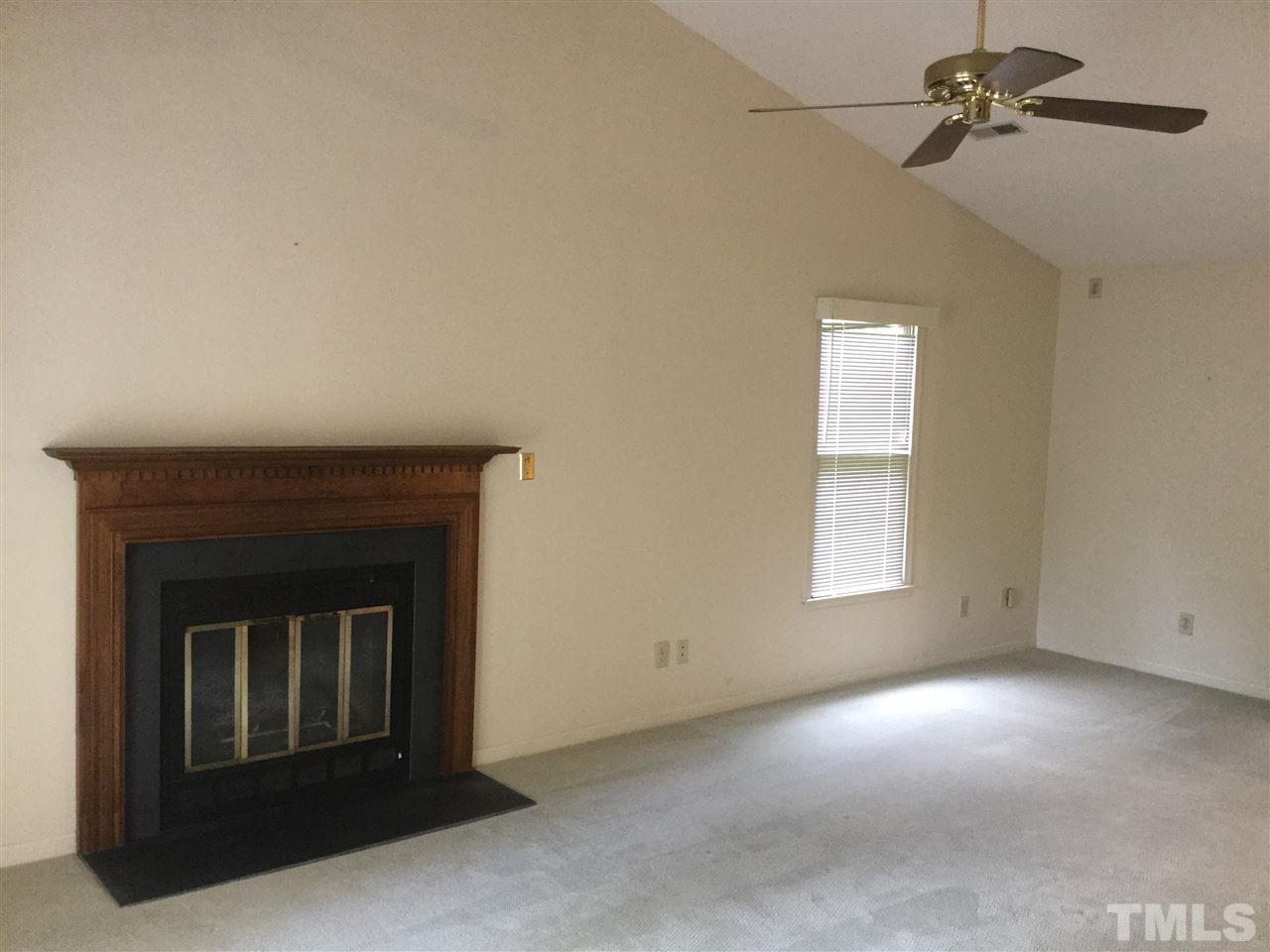 4405 Lake Ridge Drive Raleigh, NC 27604 - Photo 6 of 12 a view of empty room with a fireplace