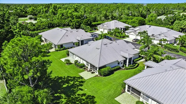 an aerial view of a house with garden space and street view