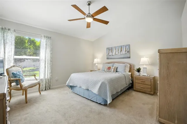 a spacious bedroom with a bed and a large window