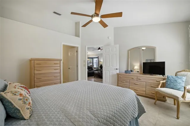 a bedroom with a bed and a television