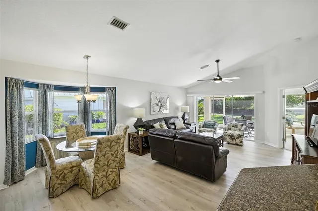 a living room with furniture potted plant and a chandelier