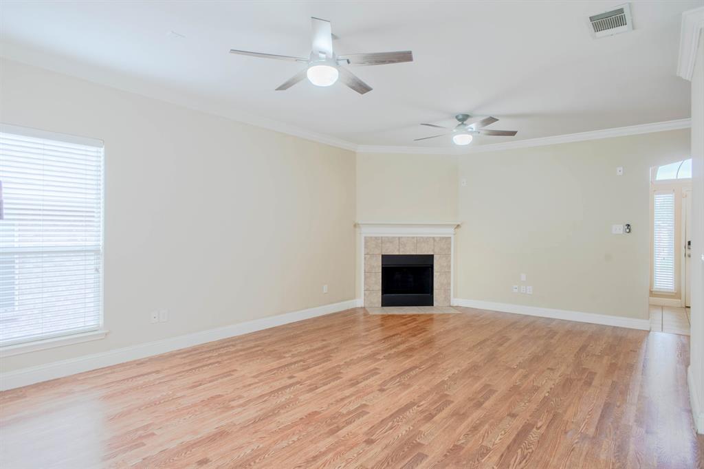 4929 Spur Ridge Court Fort Worth, TX 76244 - Photo 11 of 34 a view of empty room with wooden floor and ceiling fan