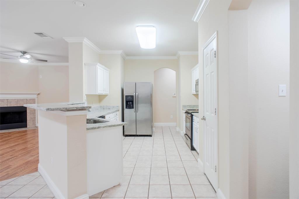 4929 Spur Ridge Court Fort Worth, TX 76244 - Photo 12 of 34 a view of a kitchen with a sink