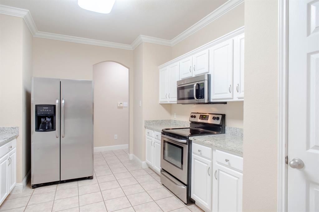 4929 Spur Ridge Court Fort Worth, TX 76244 - Photo 15 of 34 a kitchen with stainless steel appliances granite countertop a refrigerator and a stove top oven