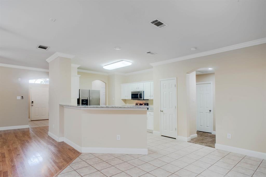 4929 Spur Ridge Court Fort Worth, TX 76244 - Photo 19 of 34 a kitchen with stainless steel appliances a refrigerator and a stove top oven