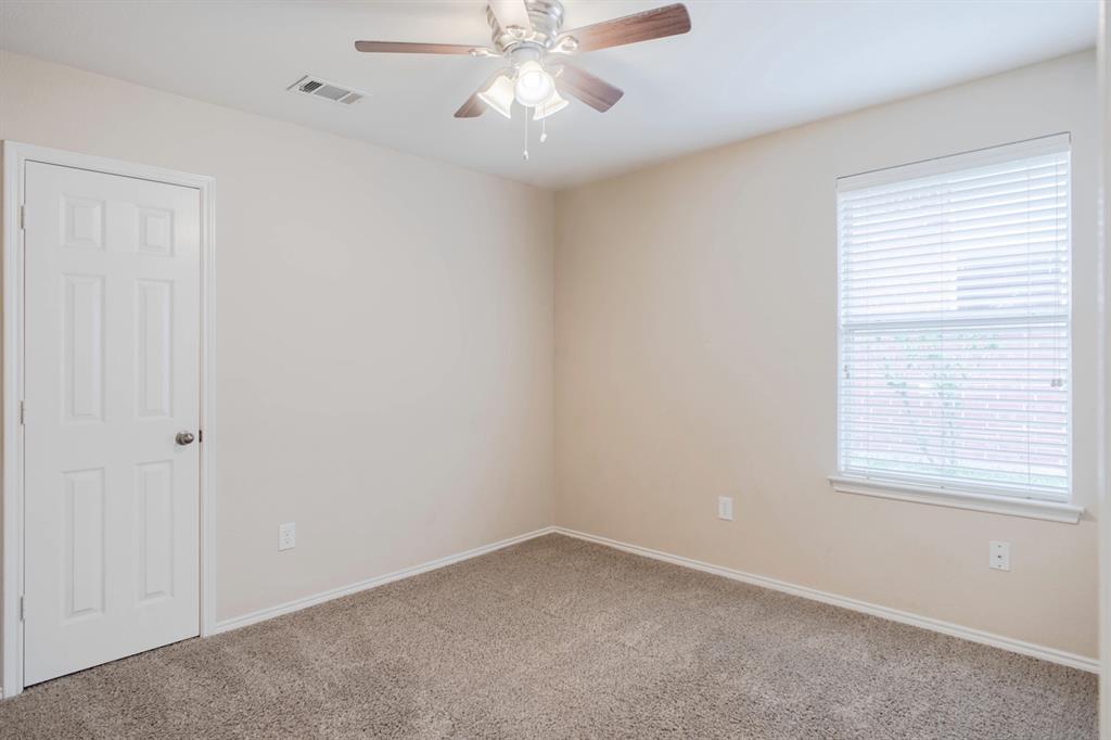 4929 Spur Ridge Court Fort Worth, TX 76244 - Photo 27 of 34 an empty room with a window and a fan