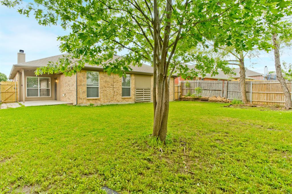 4929 Spur Ridge Court Fort Worth, TX 76244 - Photo 30 of 34 a view of a house with a yard and a tree