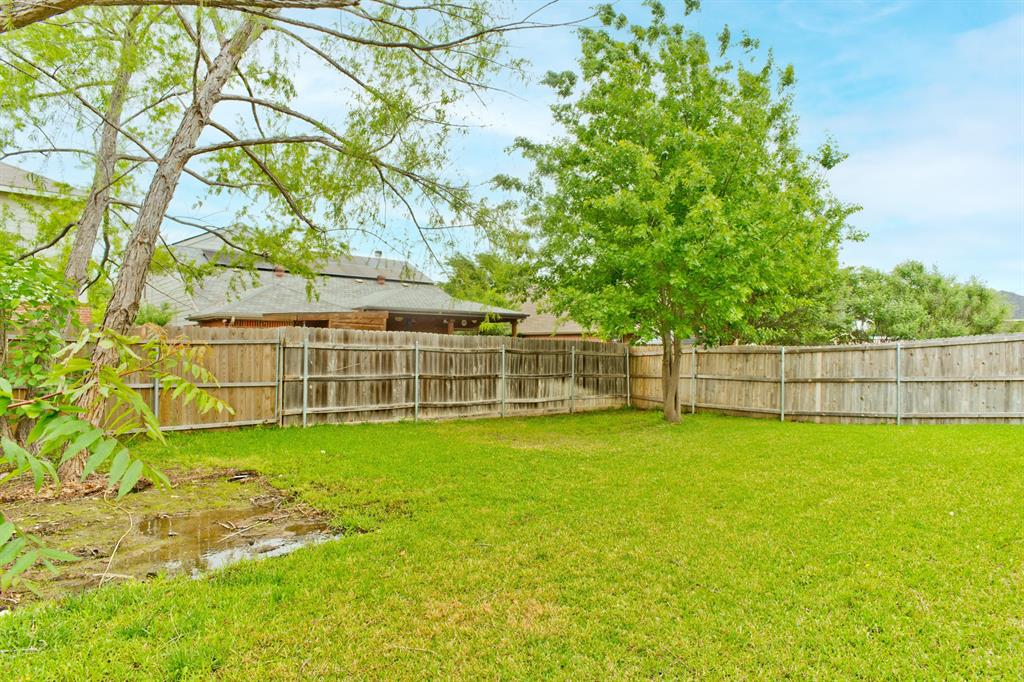4929 Spur Ridge Court Fort Worth, TX 76244 - Photo 32 of 34 a view of a yard with a large trees