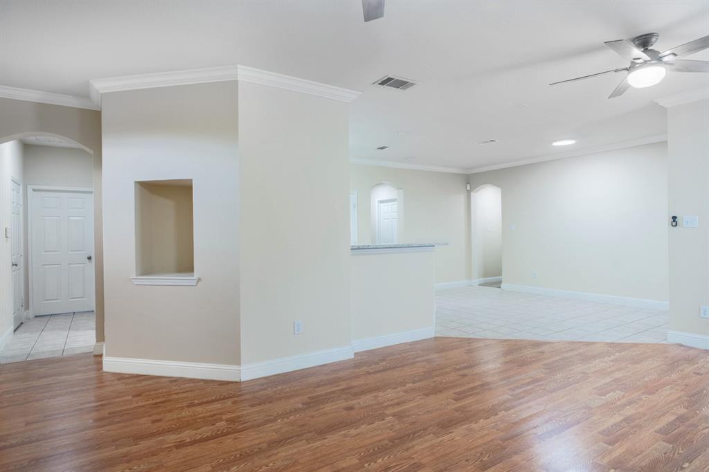 4929 Spur Ridge Court Fort Worth, TX 76244 - Photo 9 of 34 a view of an empty room with wooden floor and a window
