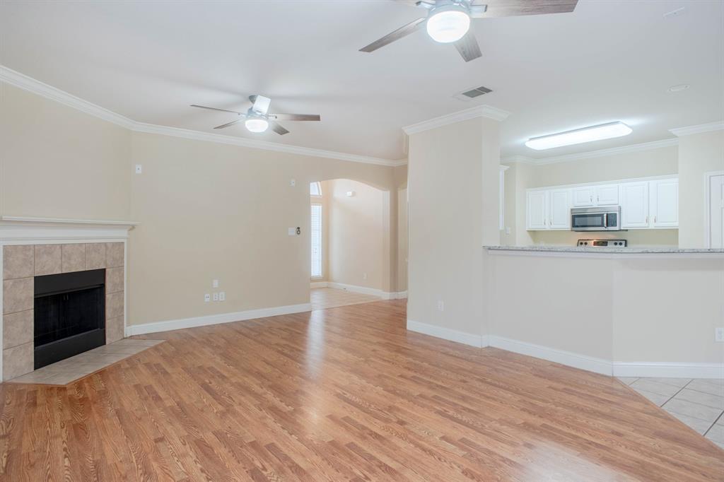 4929 Spur Ridge Court Fort Worth, TX 76244 - Photo 10 of 34 a view of an empty room with kitchen and fireplace