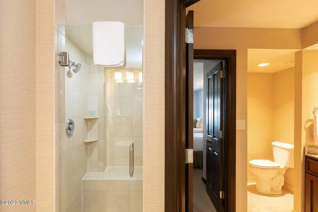 a bathroom with a glass shower door