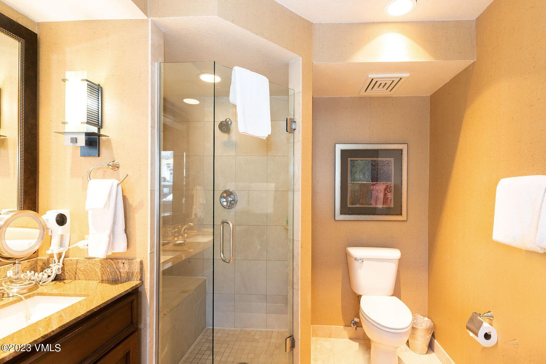 210 Offerson Road, Unit 109 WEEK 48 Beaver Creek, CO 81620 - Photo 16 of 27 a bathroom with a granite countertop sink toilet and shower