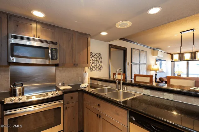 a kitchen that has a sink and a stove