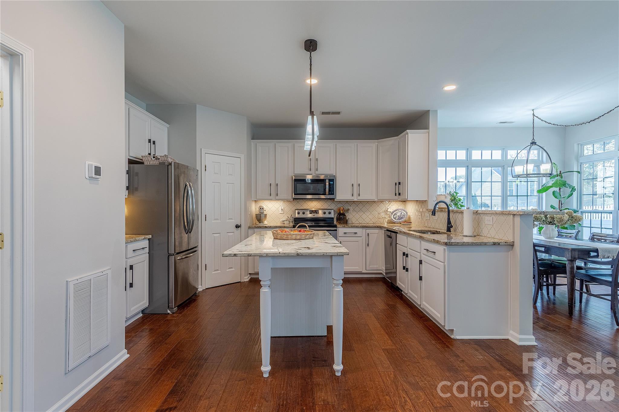5919 Summer Fog End Fort Mill, SC 29708 - Photo 12 of 41 a kitchen with refrigerator cabinets and wooden floor