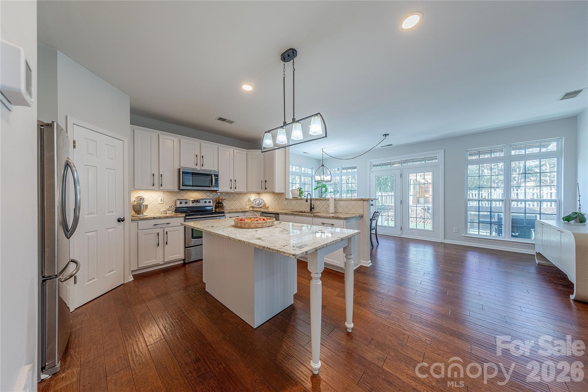 5919 Summer Fog End Fort Mill, SC 29708 - Photo 13 of 41 a kitchen with stove a refrigerator and wooden floor