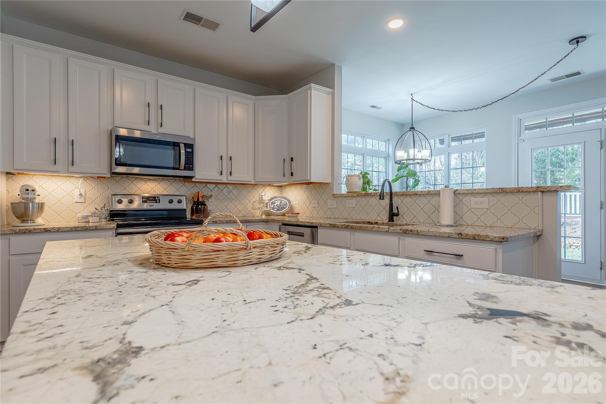 5919 Summer Fog End Fort Mill, SC 29708 - Photo 14 of 41 a kitchen with stainless steel appliances a stove a sink a microwave a refrigerator and cabinets