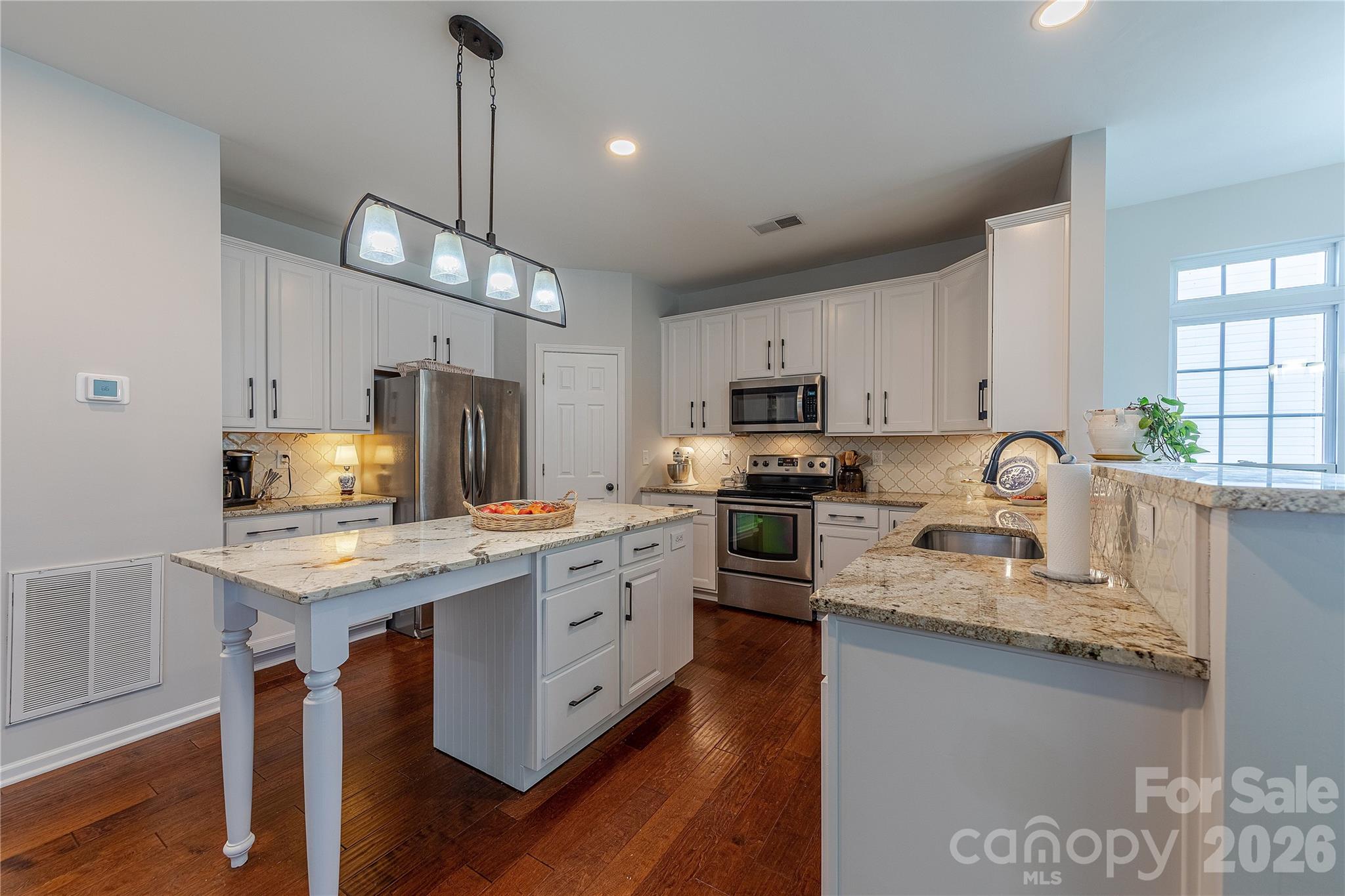 5919 Summer Fog End Fort Mill, SC 29708 - Photo 17 of 41 a kitchen with granite countertop a sink appliances cabinets and furniture