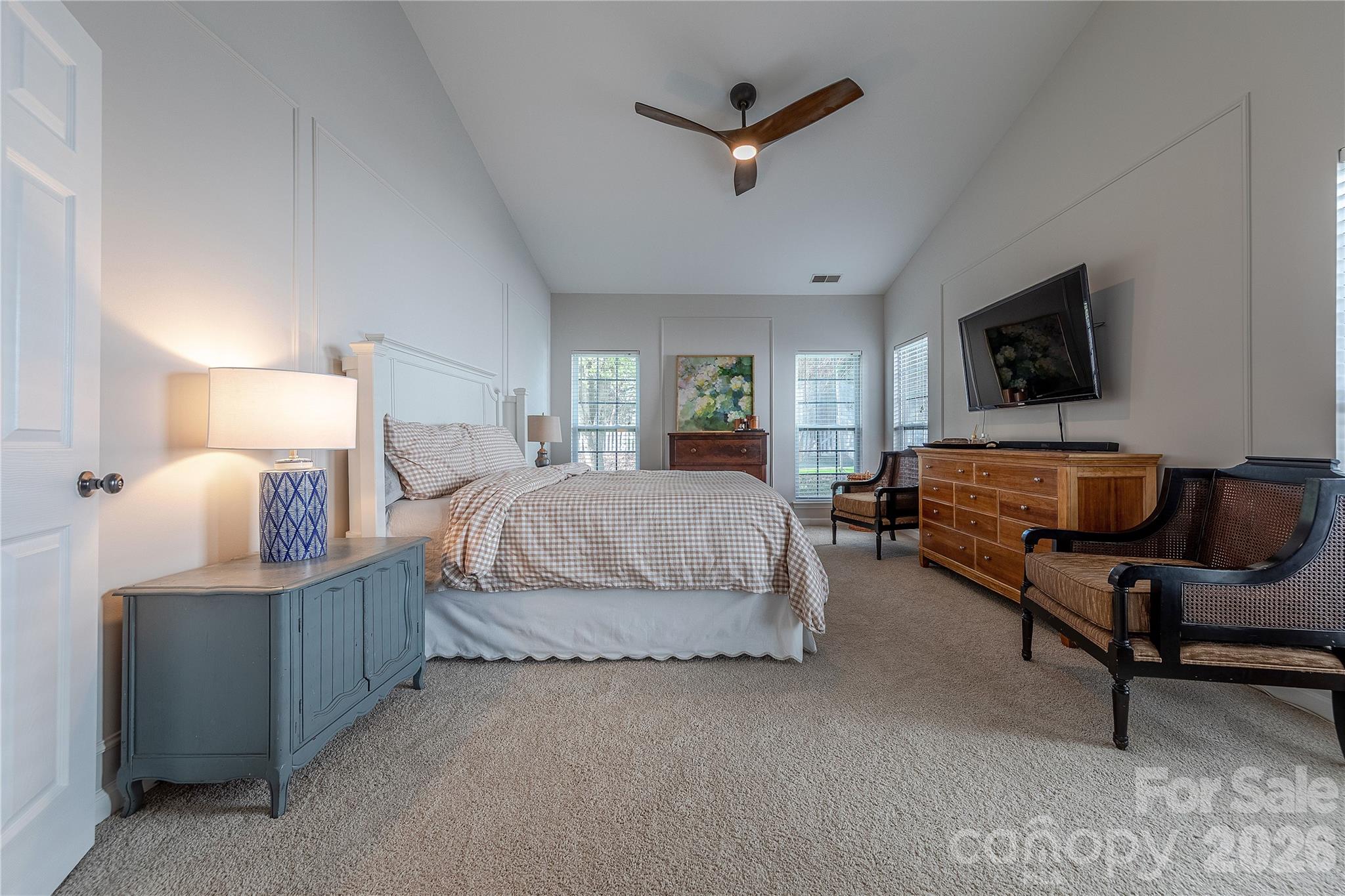 5919 Summer Fog End Fort Mill, SC 29708 - Photo 20 of 41 a spacious bedroom with a bed a couch and a flat screen tv