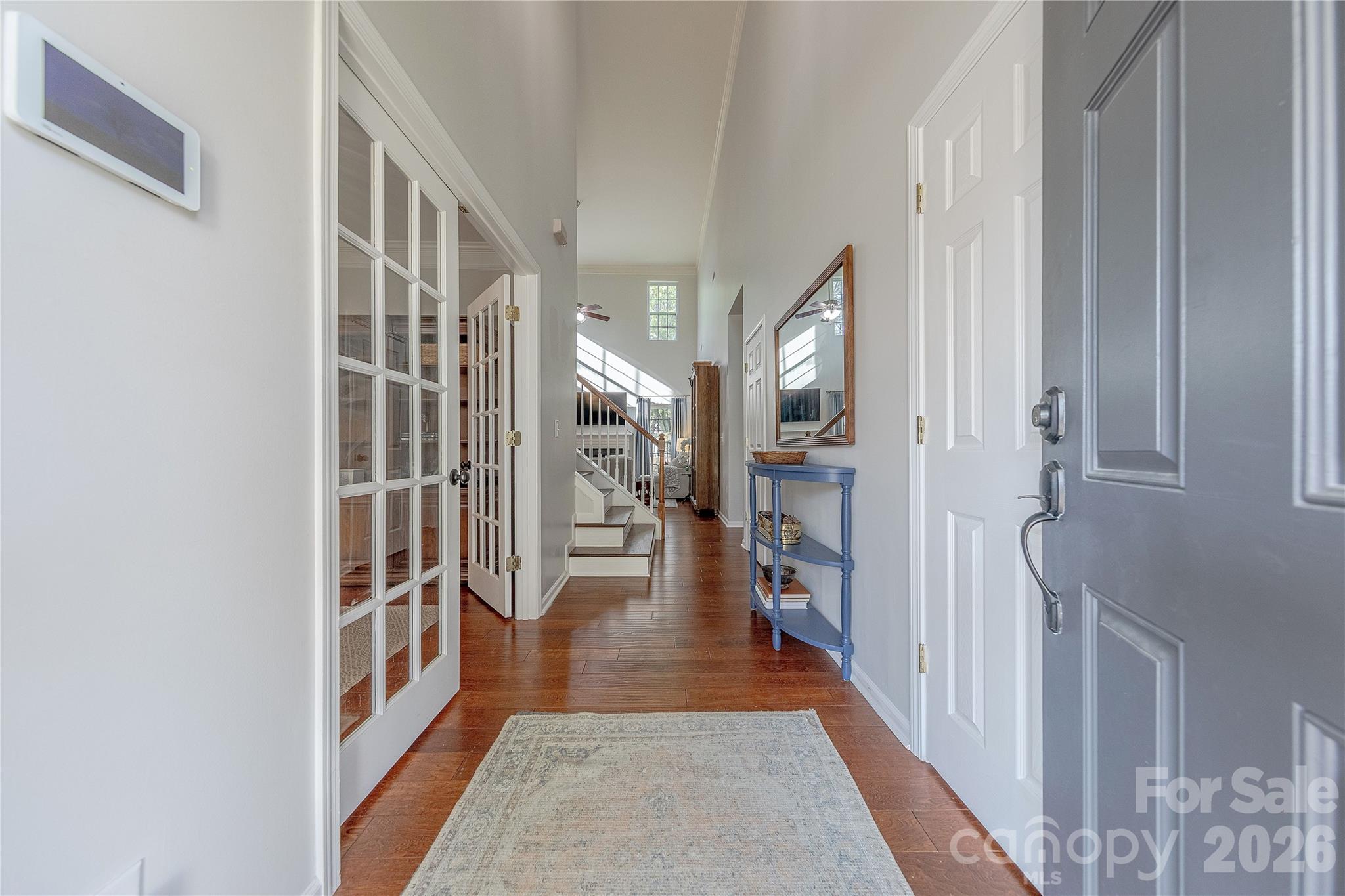 5919 Summer Fog End Fort Mill, SC 29708 - Photo 3 of 41 a hallway with wooden floor windows and a livingroom