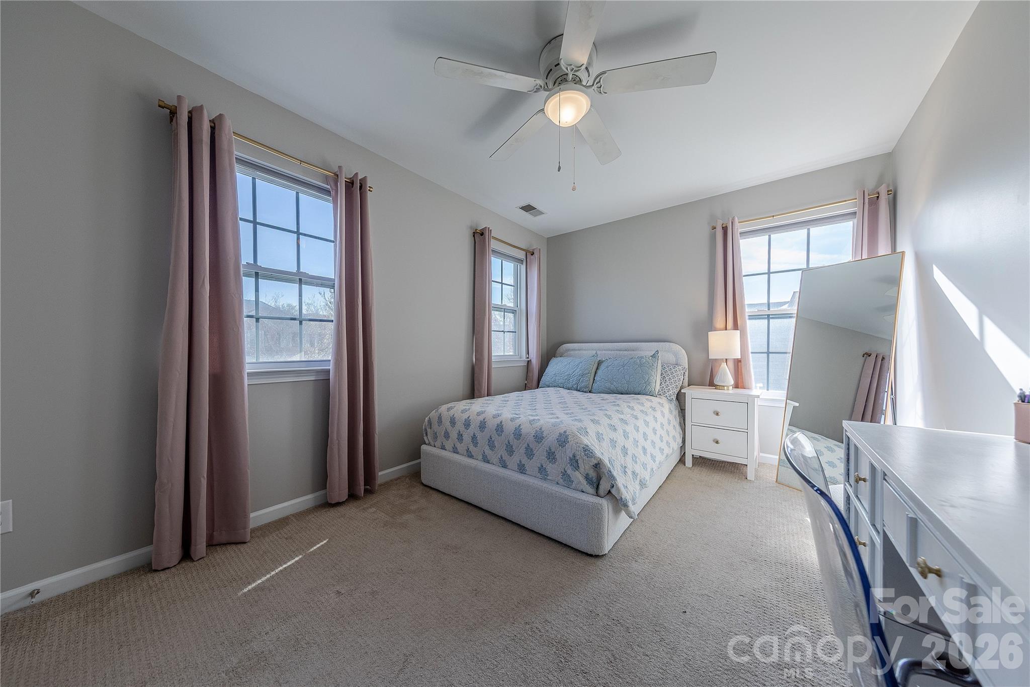 5919 Summer Fog End Fort Mill, SC 29708 - Photo 31 of 41 a spacious bedroom with a large bed and a chandelier