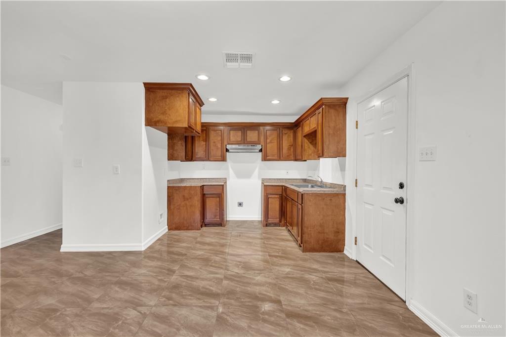 304 Santa Fe Street Alton, TX 78573 - Photo 10 of 31 a view of a kitchen with a sink and a refrigerator