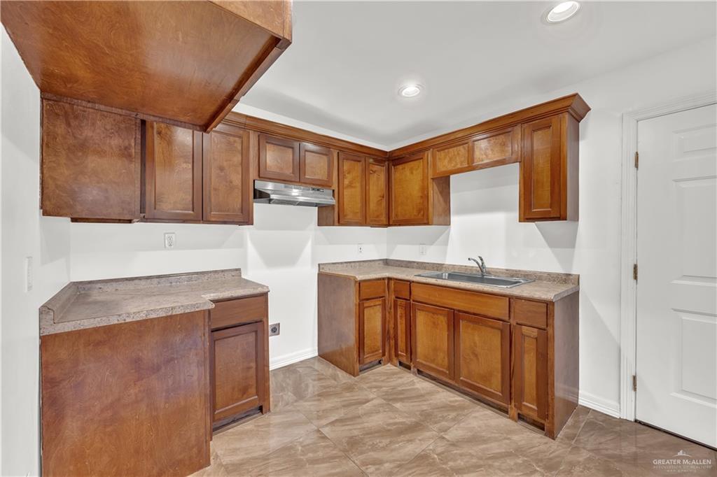 304 Santa Fe Street Alton, TX 78573 - Photo 11 of 31 a kitchen with stainless steel appliances granite countertop a sink stove and cabinets