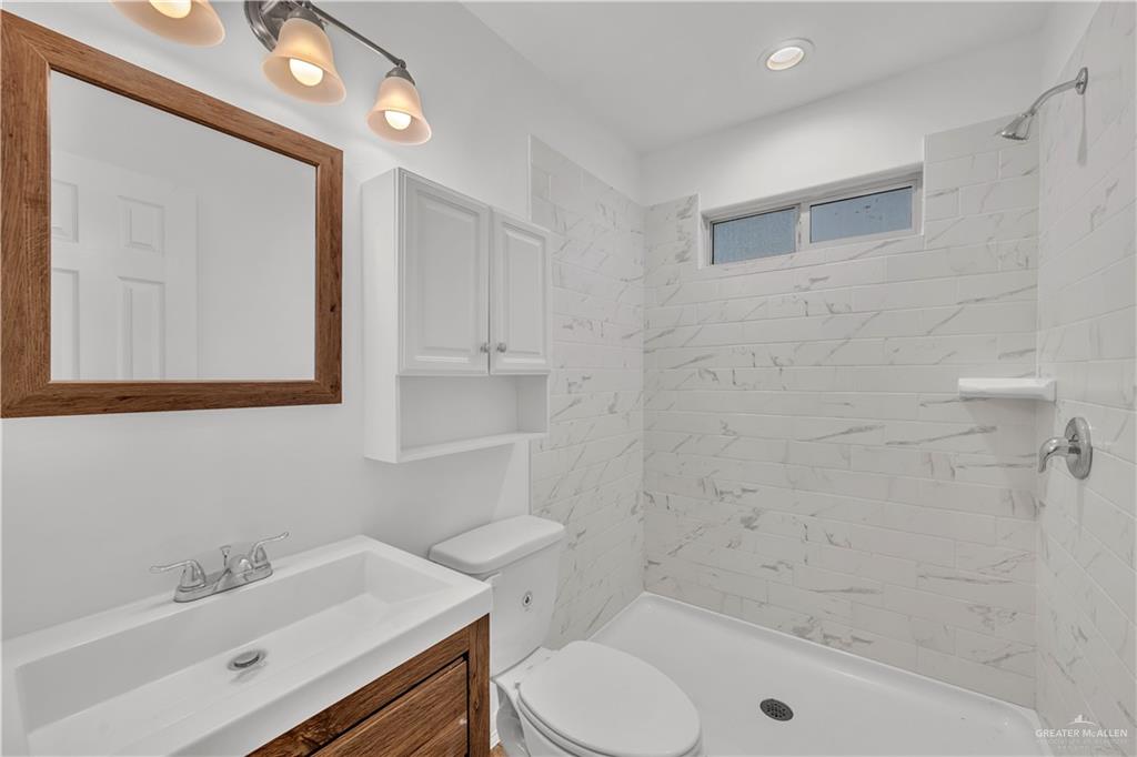 304 Santa Fe Street Alton, TX 78573 - Photo 14 of 31 a bathroom with a sink a toilet and shower