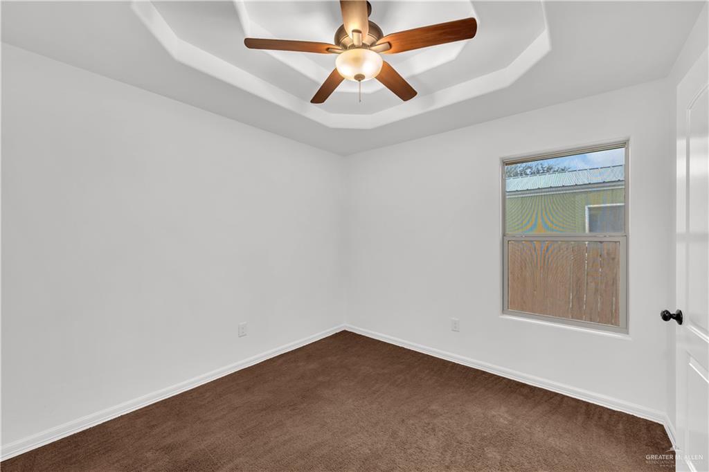 304 Santa Fe Street Alton, TX 78573 - Photo 16 of 31 an empty room with a window and a fan