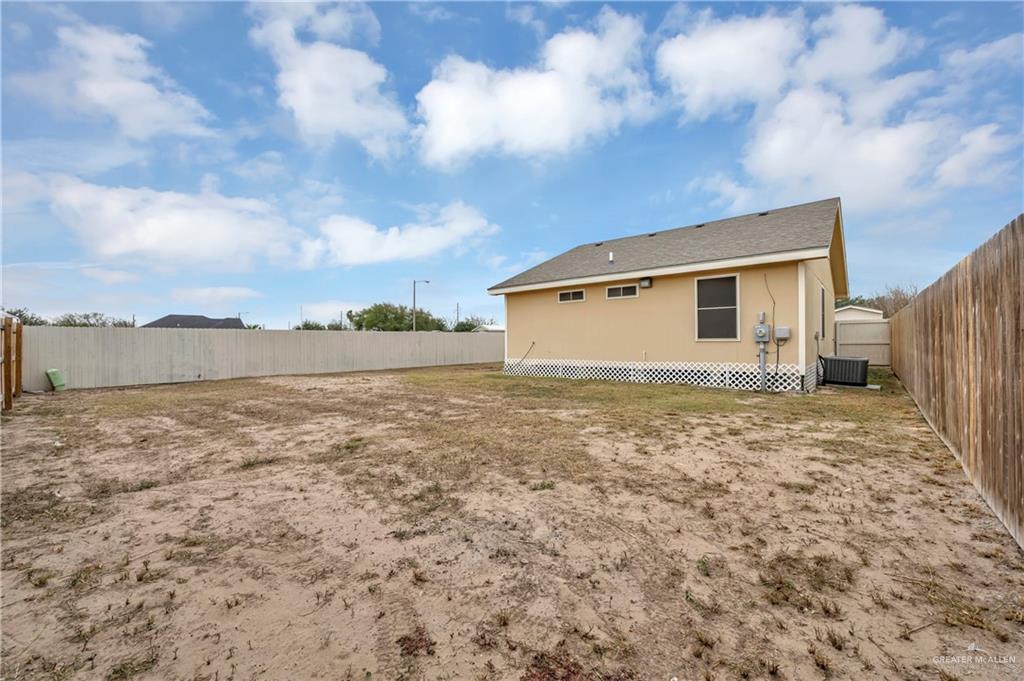 304 Santa Fe Street Alton, TX 78573 - Photo 24 of 31 a view of a house with backyard and wooden fence