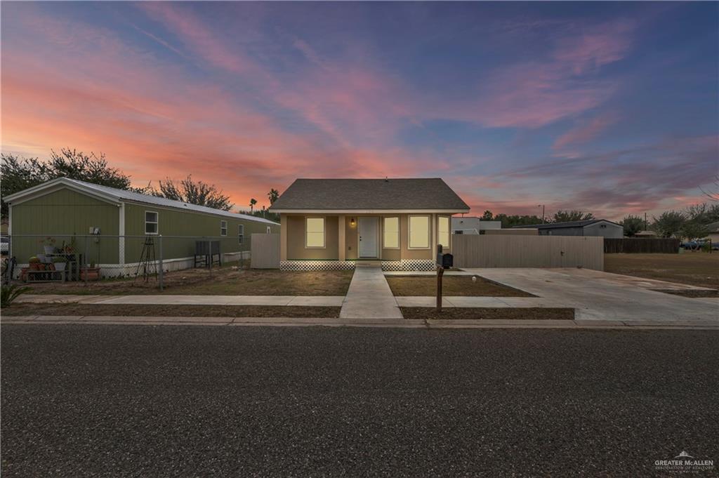 304 Santa Fe Street Alton, TX 78573 - Photo 4 of 31 a front view of a house with a yard