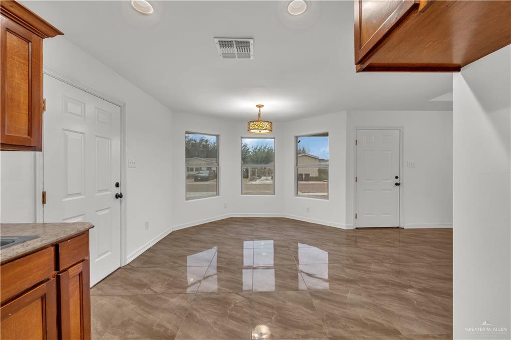 304 Santa Fe Street Alton, TX 78573 - Photo 7 of 31 a view of an empty room with window and wooden floor