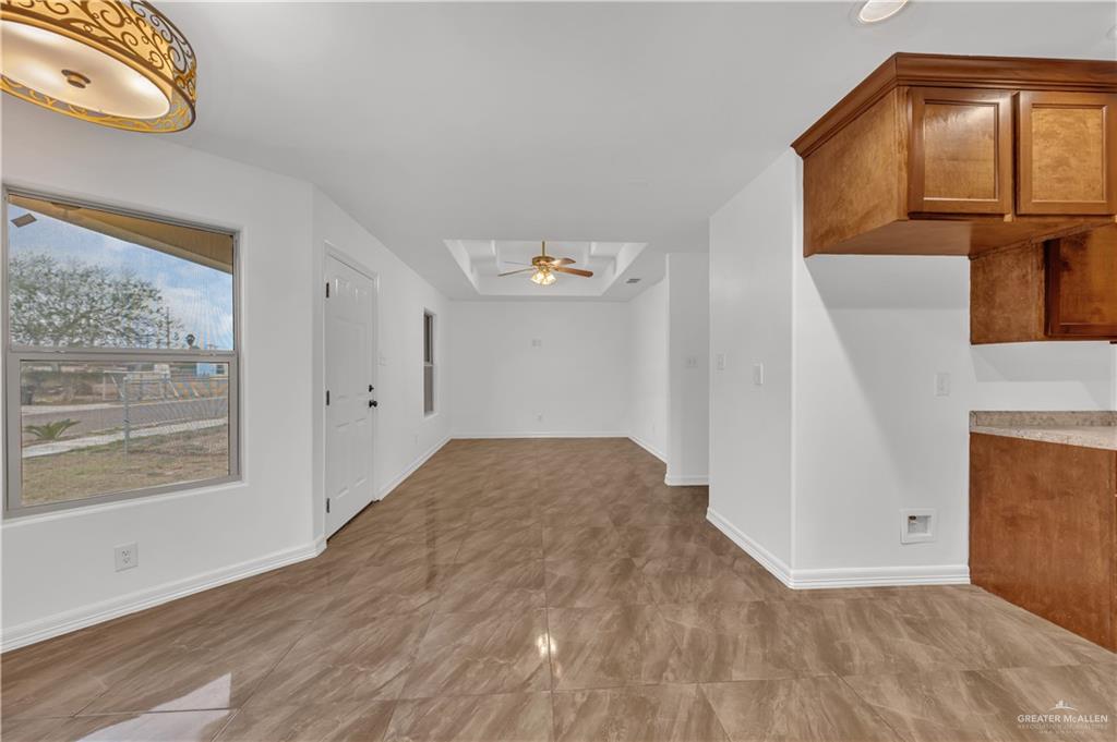 304 Santa Fe Street Alton, TX 78573 - Photo 9 of 31 a view of empty room with wooden floor and fan