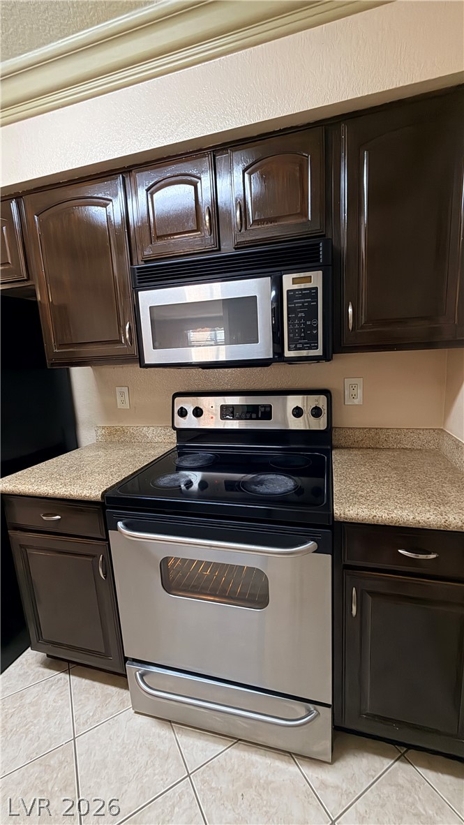 8101 West Flamingo Road, Unit 1082 Las Vegas, NV 89147 - Photo 18 of 23 Equipped for culinary adventures, this kitchen features a stainless steel range and coordinating microwave.