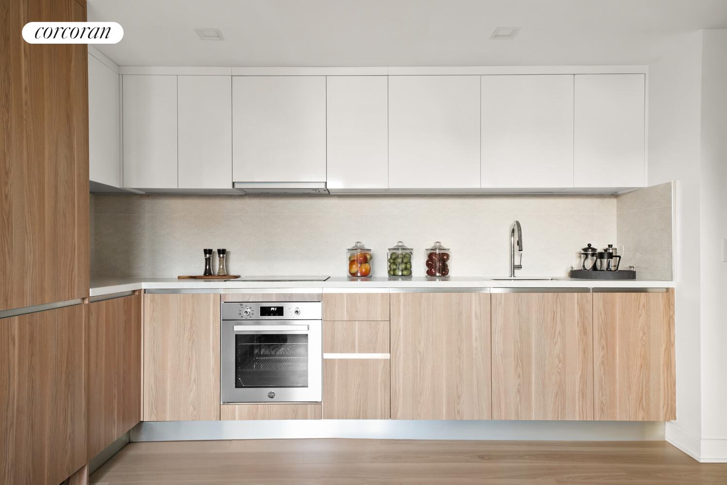 27-09 40th Avenue, Unit 6F Queens, NY 11101 - Photo 3 of 11 a kitchen with white cabinets and wooden floor