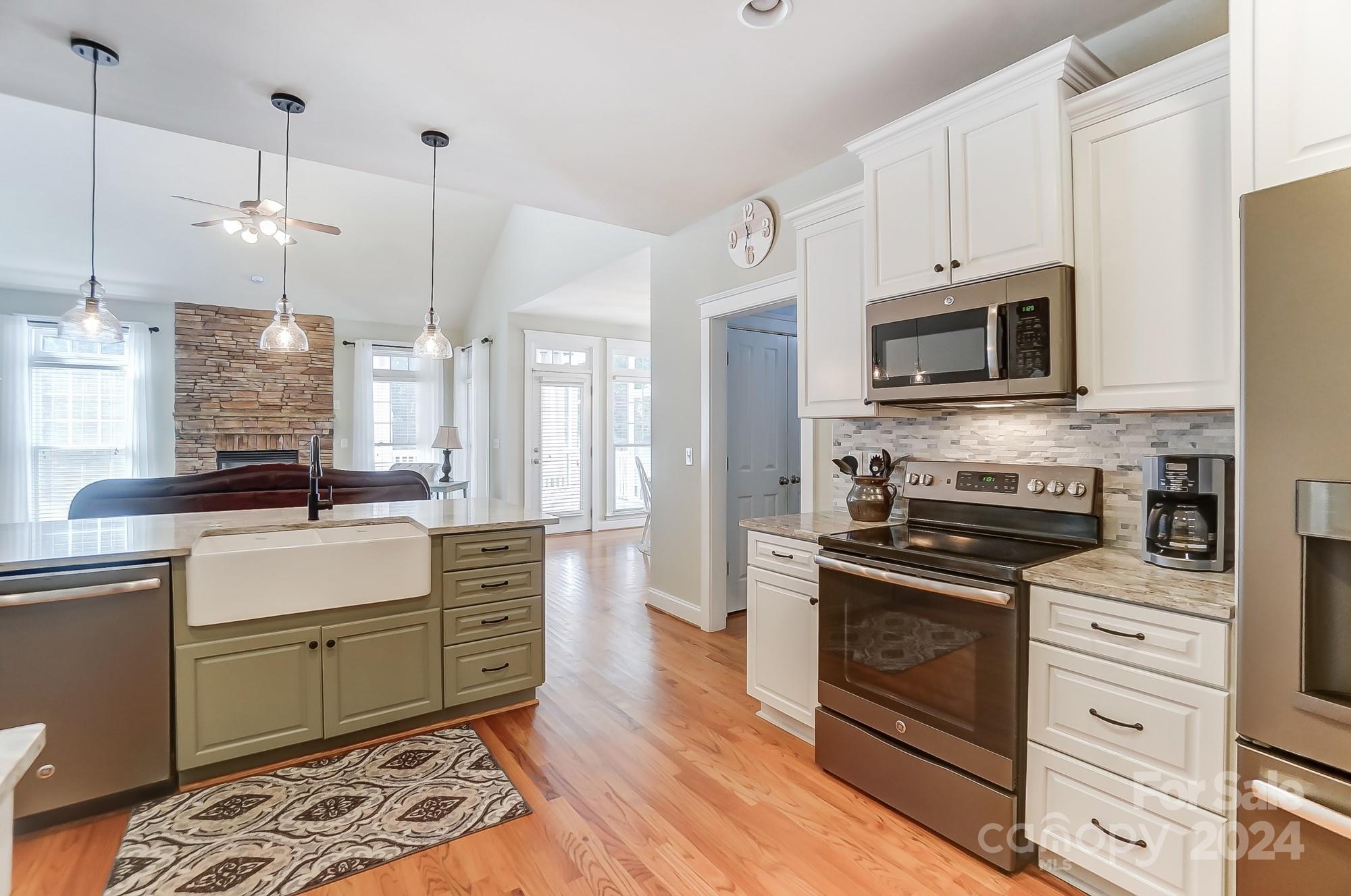 169 Mills Lane Fort Mill, SC 29708 - Photo 11 of 38 a kitchen with stainless steel appliances kitchen island granite countertop a stove a sink and a refrigerator