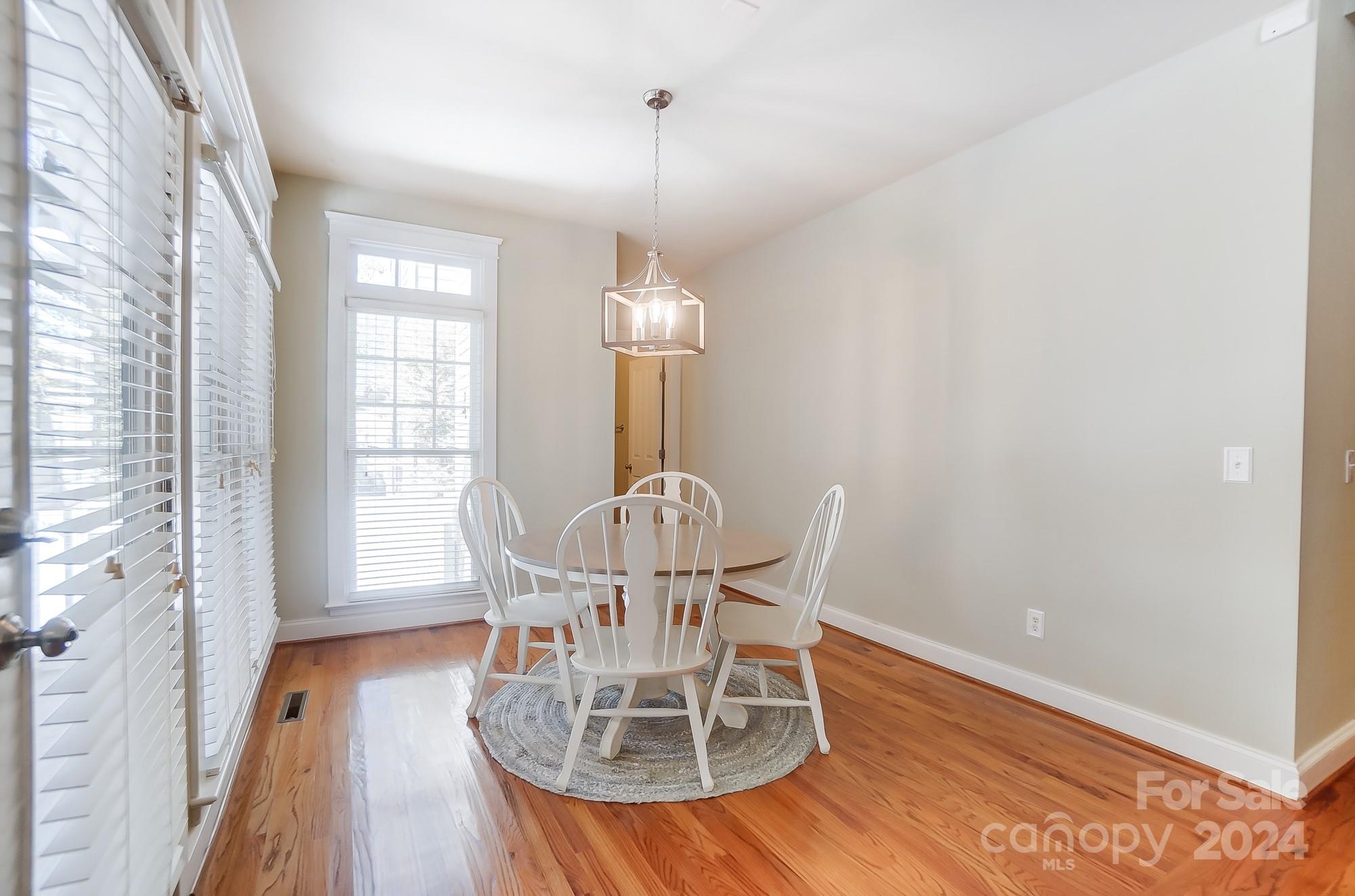 169 Mills Lane Fort Mill, SC 29708 - Photo 15 of 38 a view of a dining room with furniture window and wooden floor