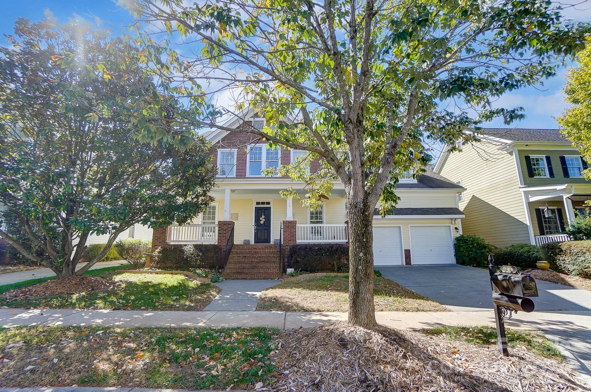 169 Mills Lane Fort Mill, SC 29708 - Photo 2 of 38 a front view of a house with garden and trees