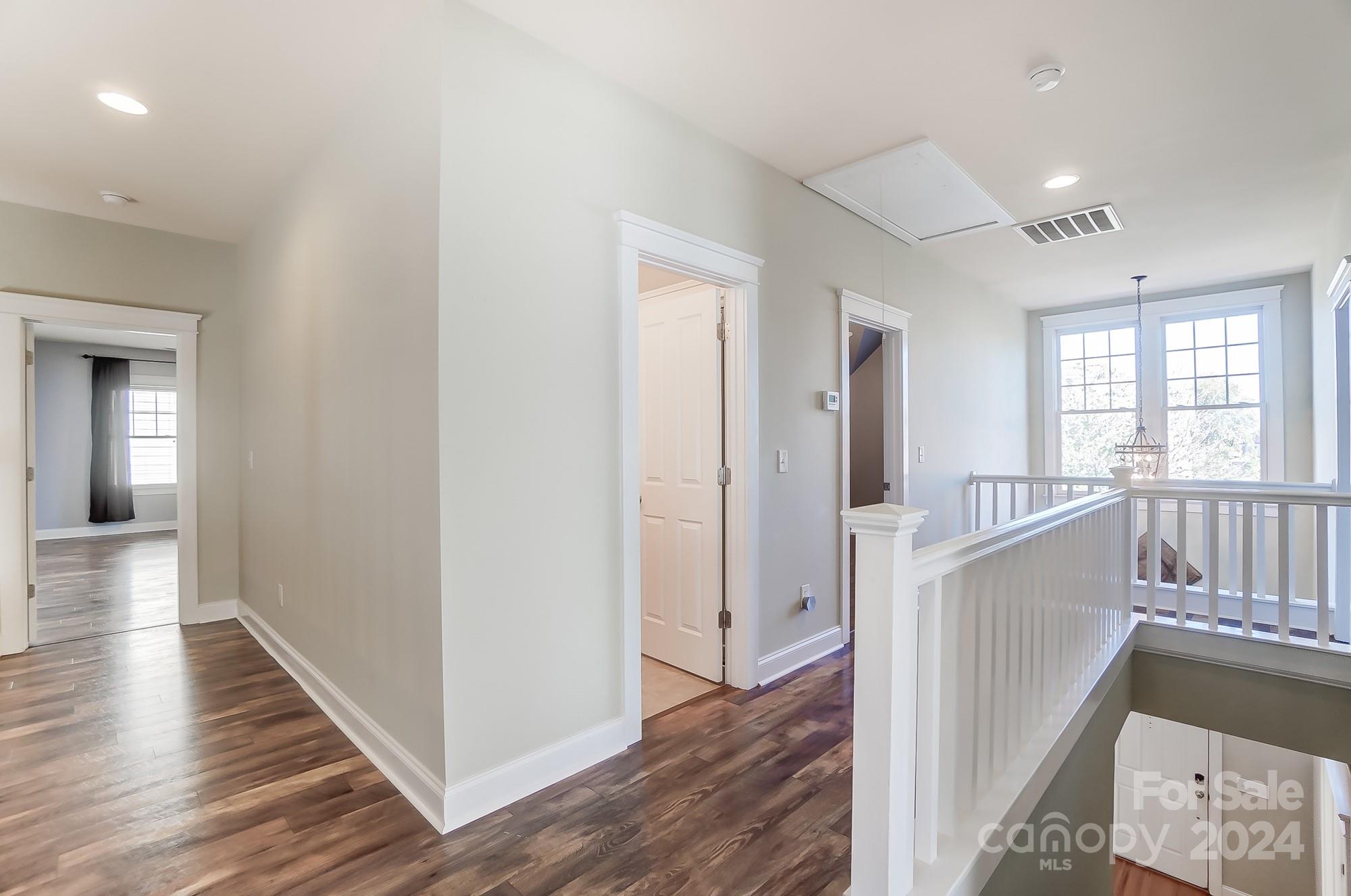169 Mills Lane Fort Mill, SC 29708 - Photo 22 of 38 a view of a hallway with wooden floor and staircase